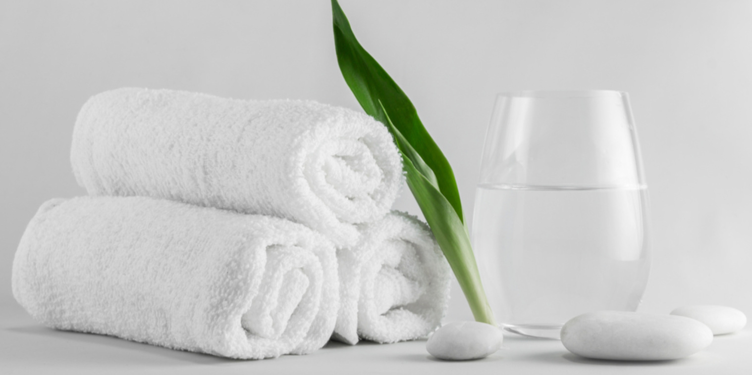 white towels and glass of water inside a sauna spa
