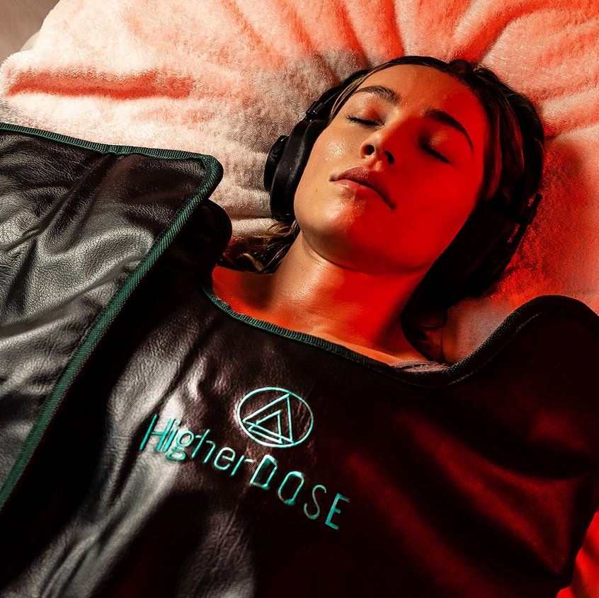 woman relaxing in a higherdose infrared sauna blanket