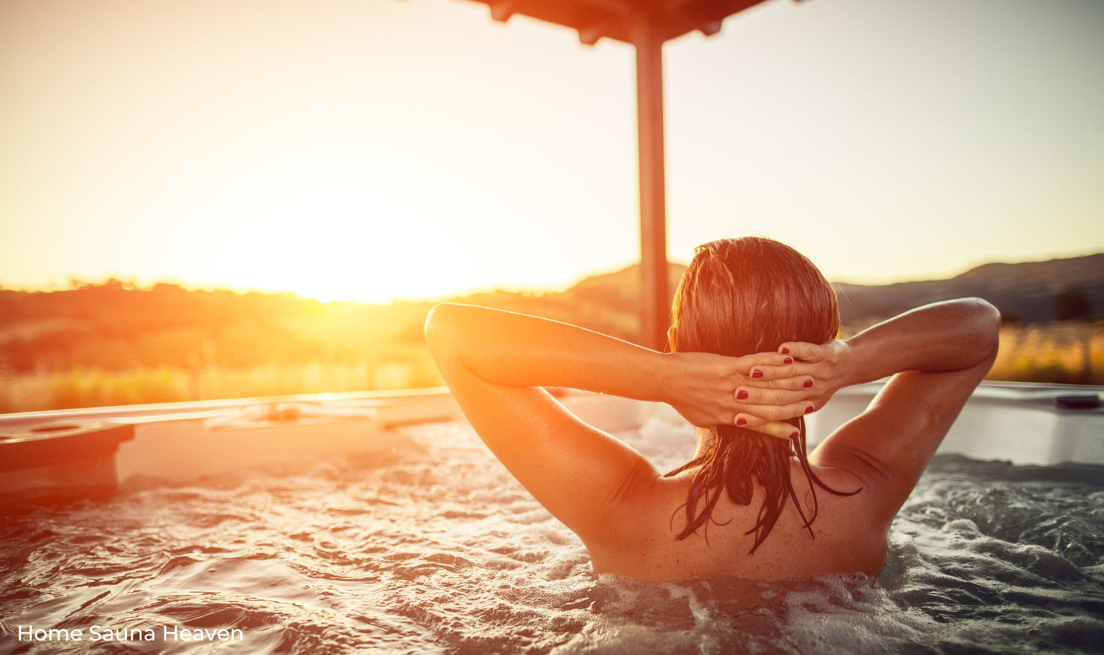 woman sitting in a hot tub and watching the sun set