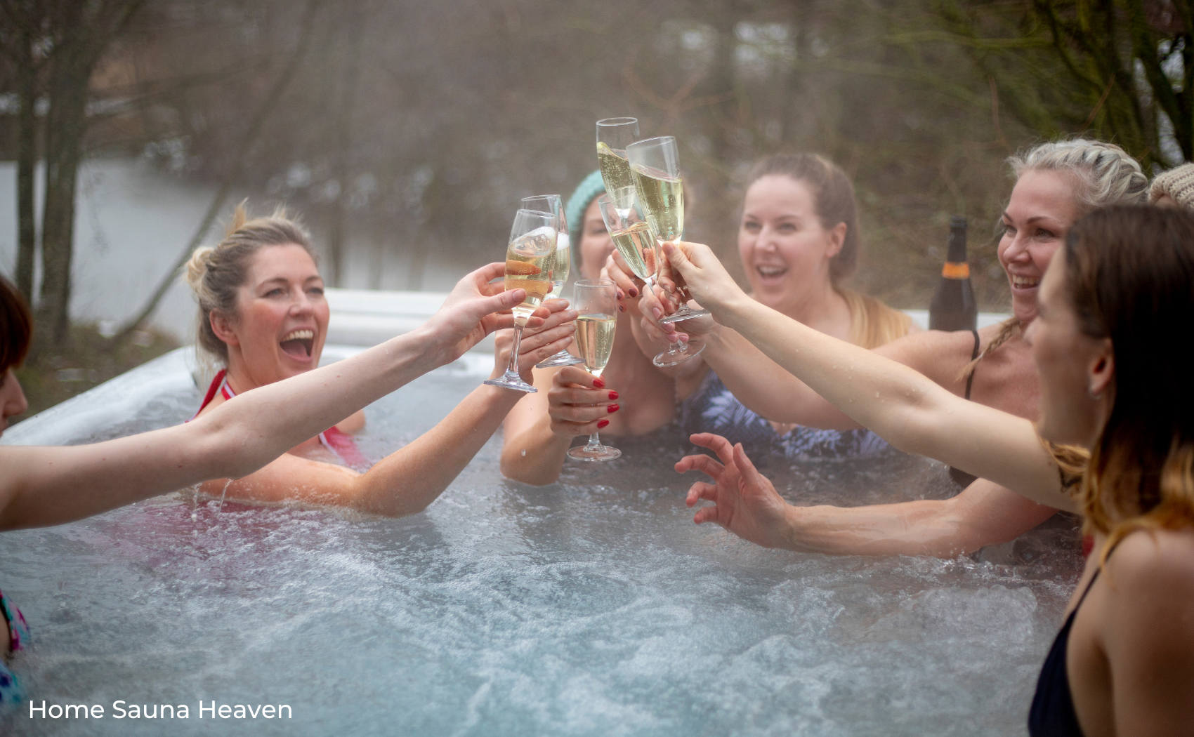 women having a glass of prosecco in a hot tub