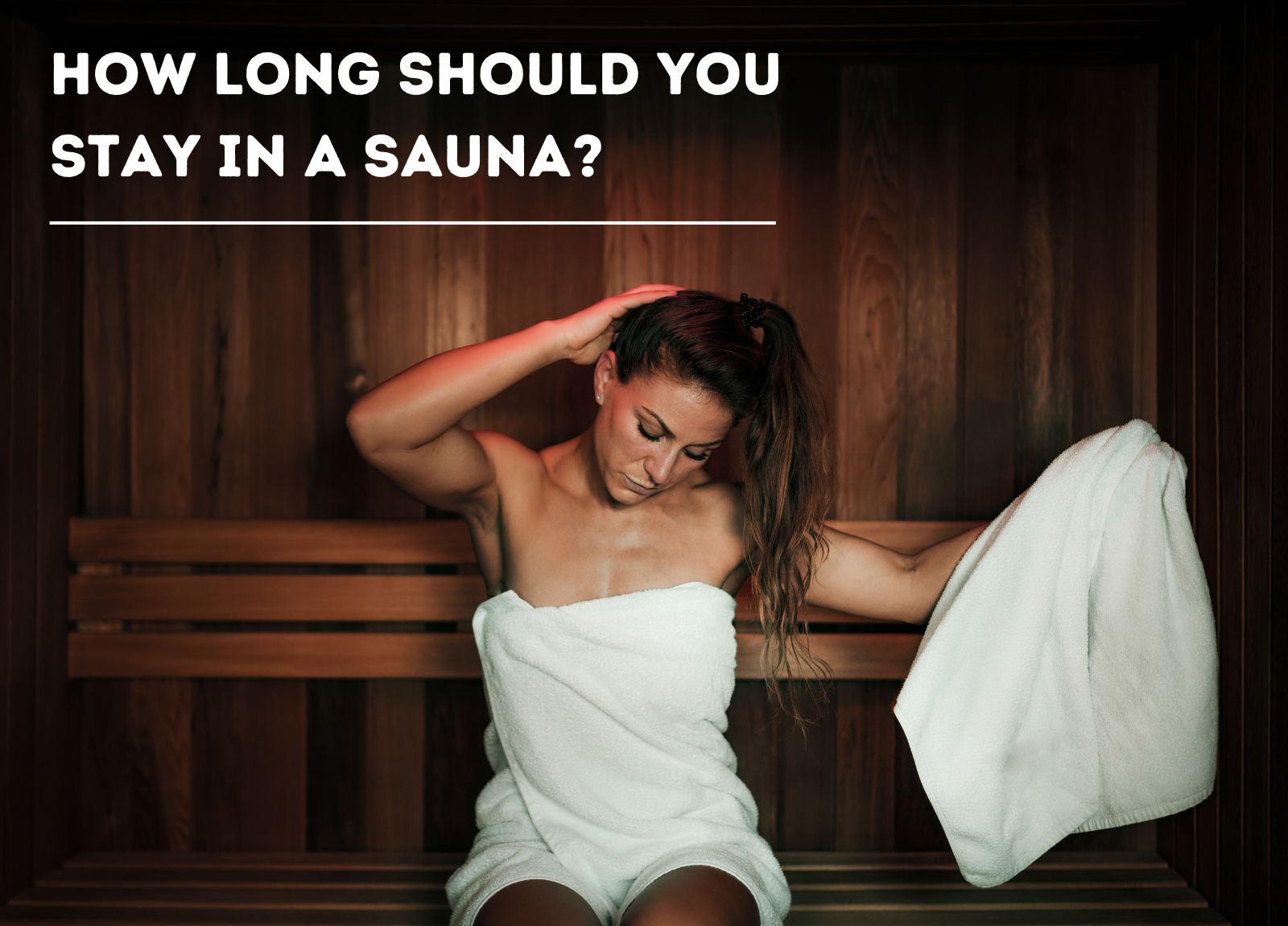 woman sitting on a sauna bench with a white towel